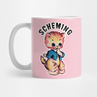 Scheming kitten Mug